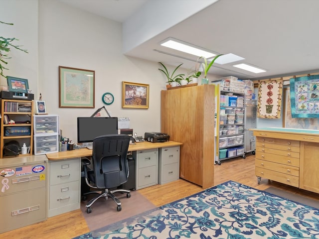 home office with light wood-style floors