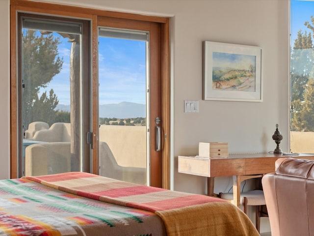 bedroom with multiple windows and a mountain view