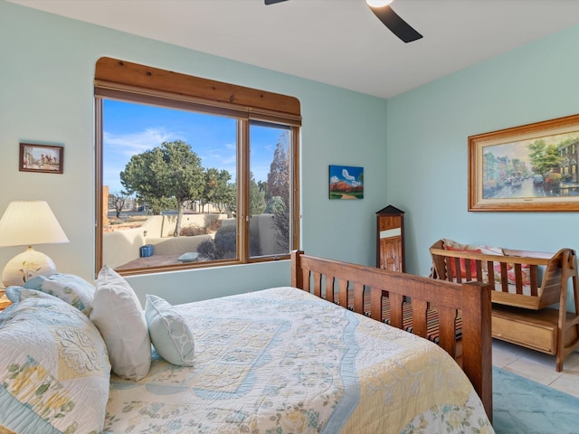 tiled bedroom featuring a ceiling fan