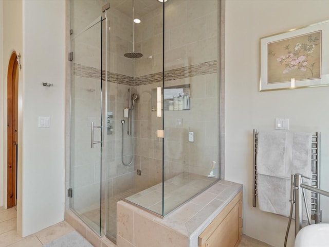 full bathroom featuring a stall shower and tile patterned flooring