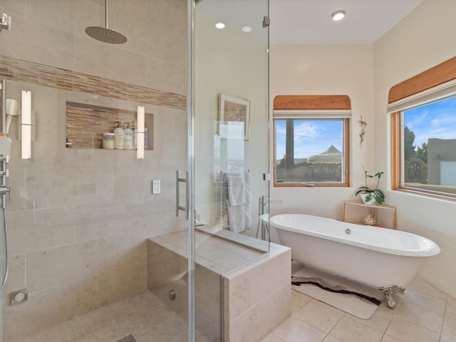 full bath with a soaking tub, a shower stall, and tile patterned flooring