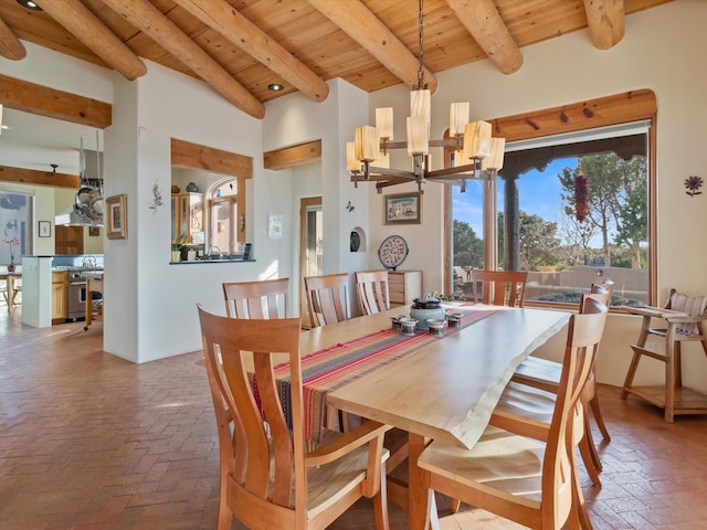 dining space with wooden ceiling, beamed ceiling, brick floor, and a chandelier