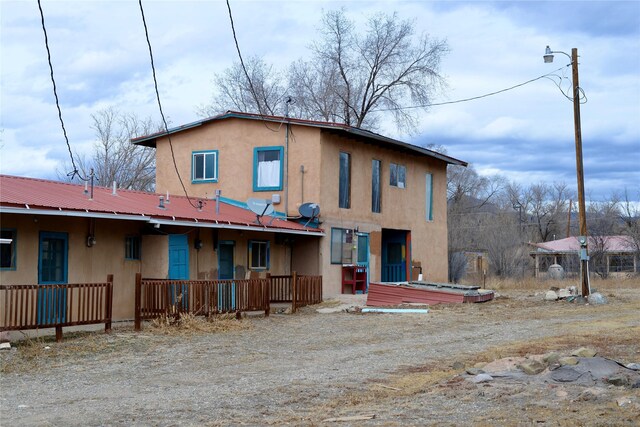 rear view of house featuring metal roof