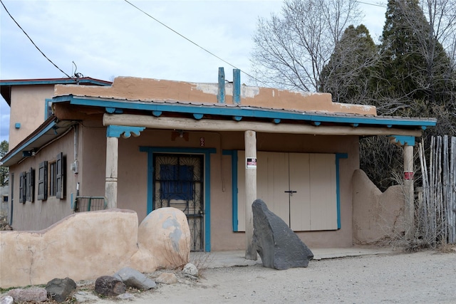 exterior space featuring metal roof and covered porch