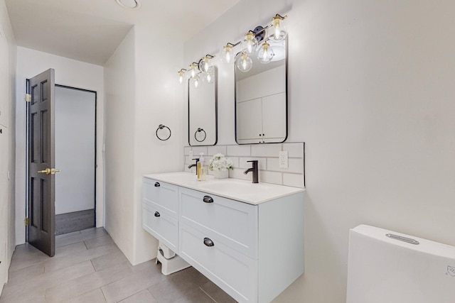 full bathroom with a sink, decorative backsplash, double vanity, and tile patterned flooring