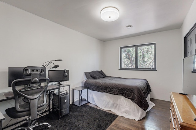 bedroom featuring dark wood finished floors