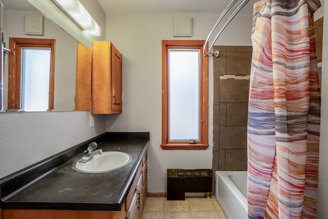 full bathroom with vanity, baseboards, and shower / bath combo