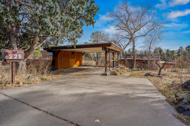 view of patio featuring an attached carport and concrete driveway