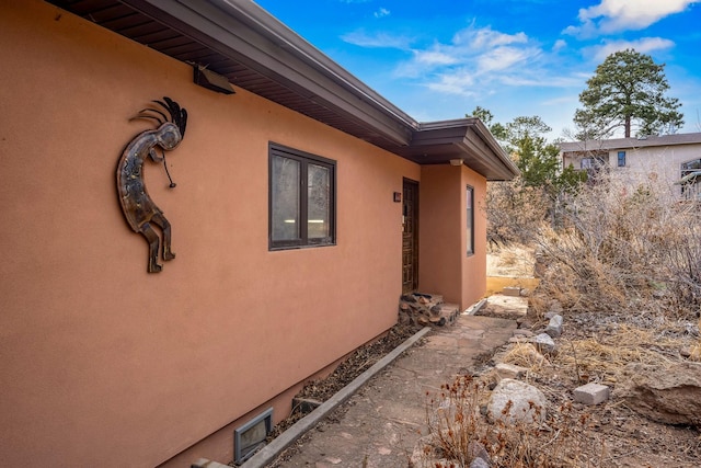 view of side of property with stucco siding