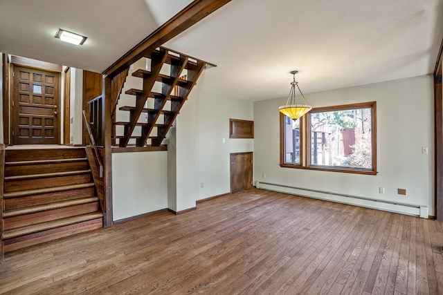 unfurnished living room featuring stairway, wood-type flooring, baseboards, and baseboard heating