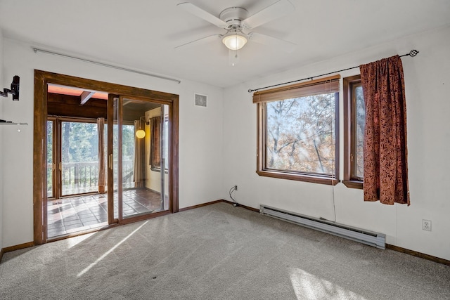 carpeted spare room featuring visible vents, a healthy amount of sunlight, baseboards, and a baseboard radiator