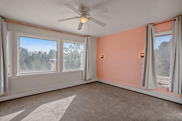 carpeted spare room with a baseboard heating unit and ceiling fan