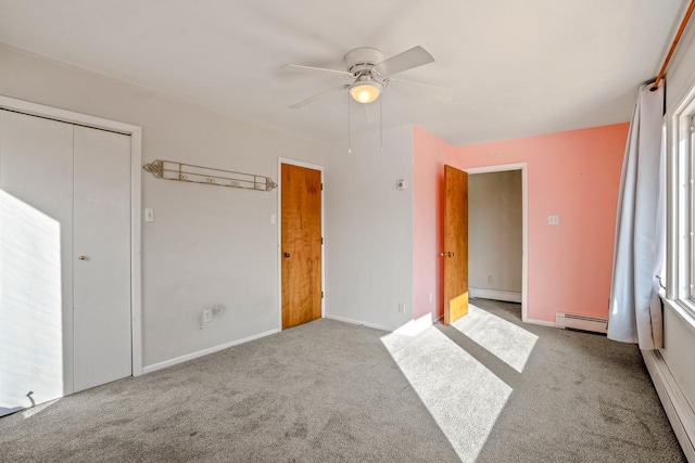 unfurnished bedroom with carpet flooring, a baseboard heating unit, ceiling fan, and a baseboard radiator