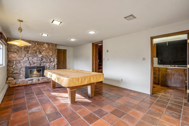 playroom with a stone fireplace and pool table