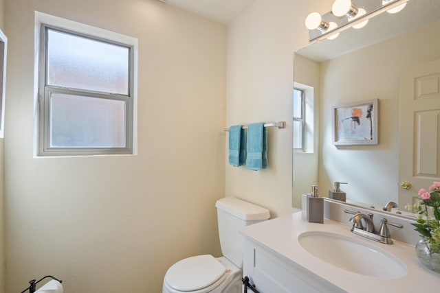 bathroom with toilet and vanity