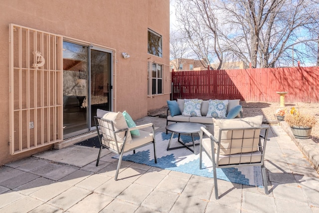 view of patio / terrace with an outdoor living space and fence