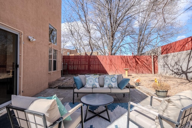 view of patio / terrace featuring an outdoor living space and a fenced backyard