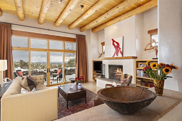 living room with french doors, beam ceiling, wood ceiling, and a fireplace