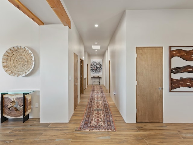 hall featuring recessed lighting, beamed ceiling, and wood finished floors