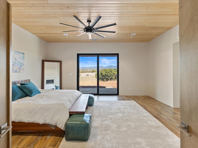 bedroom with wood finished floors, wood ceiling, access to exterior, and a ceiling fan