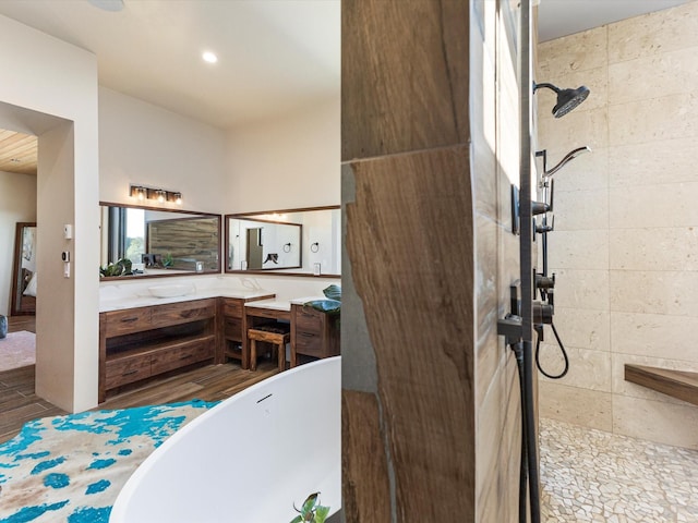 full bathroom featuring vanity, a soaking tub, recessed lighting, and walk in shower