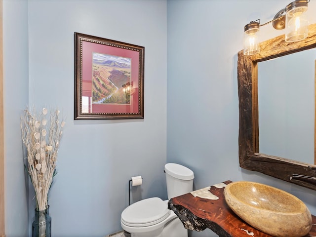 bathroom featuring toilet and a sink