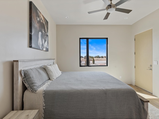 bedroom featuring light wood-style flooring and ceiling fan