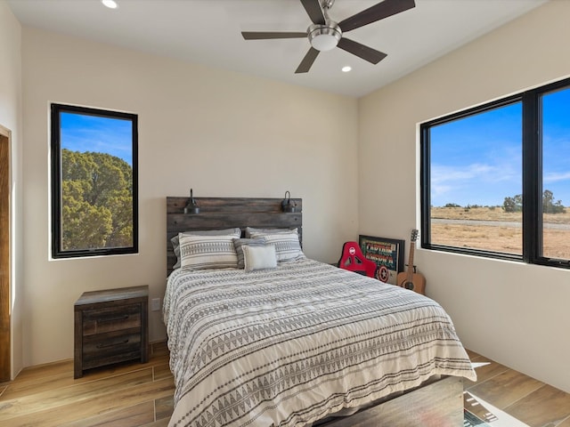 bedroom with a ceiling fan, recessed lighting, and wood finished floors