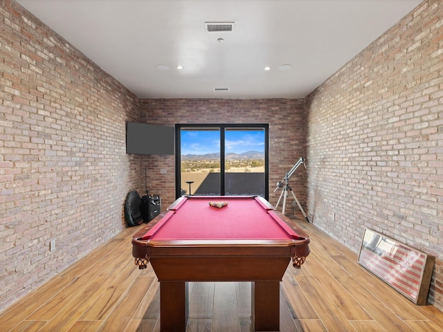 playroom featuring visible vents, brick wall, pool table, and wood finished floors