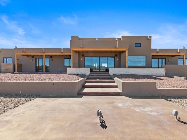 rear view of property with stucco siding