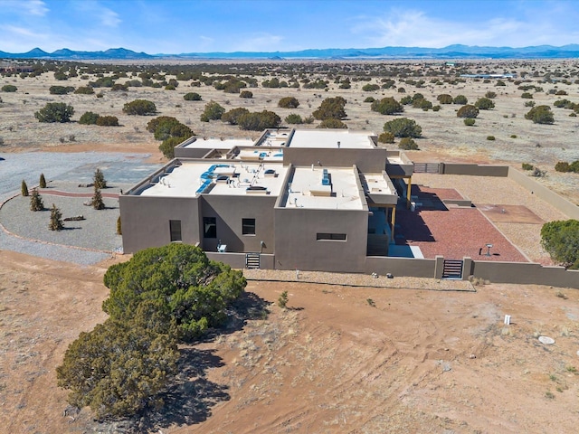 drone / aerial view featuring a mountain view and a desert view