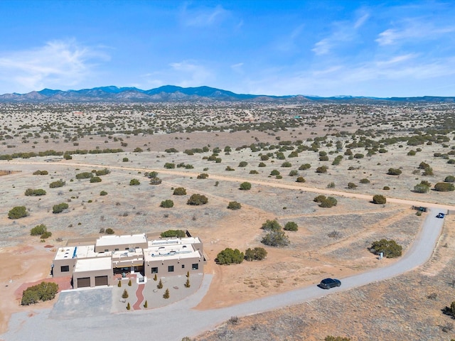 aerial view featuring a desert view and a mountain view