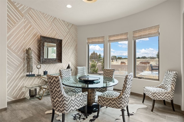 dining area featuring recessed lighting, baseboards, an accent wall, and wallpapered walls