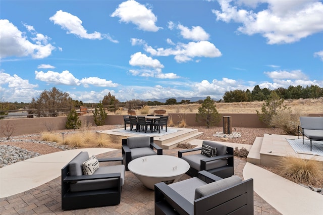 view of patio with an outdoor living space, outdoor dining area, and fence