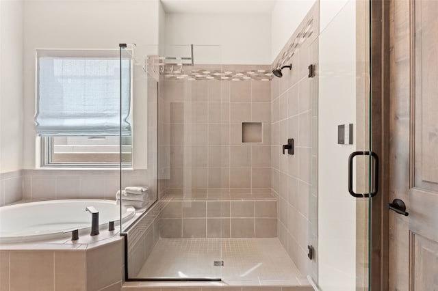 bathroom with a garden tub and a shower stall