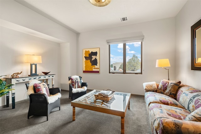 living room with visible vents, baseboards, and carpet