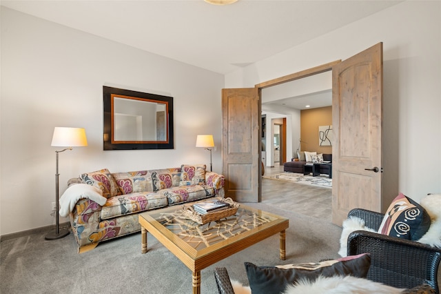 living area featuring carpet flooring and baseboards