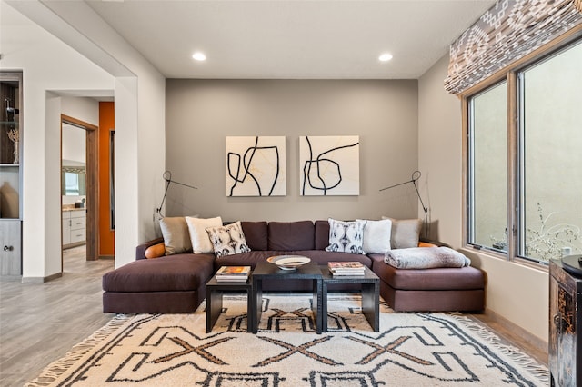 living room with recessed lighting, baseboards, and wood finished floors