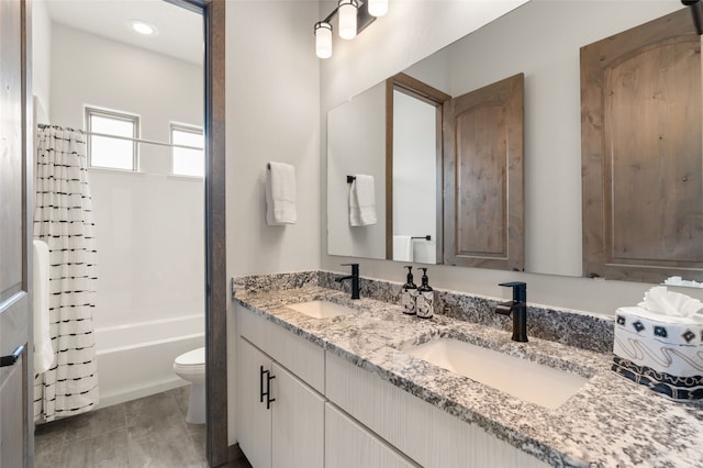 full bathroom featuring double vanity, toilet, shower / tub combo, and a sink