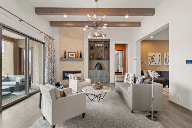 living area featuring recessed lighting, beam ceiling, a notable chandelier, and a fireplace