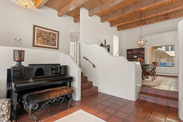 staircase featuring baseboard heating, wooden ceiling, beamed ceiling, a notable chandelier, and tile patterned floors