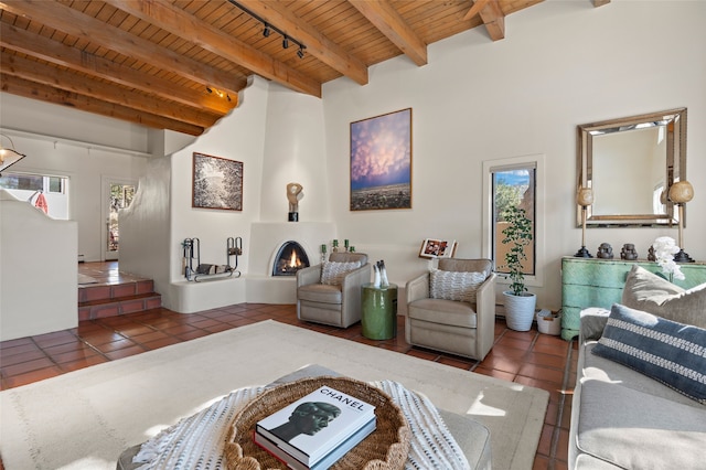 tiled living area featuring wooden ceiling, beamed ceiling, and a fireplace