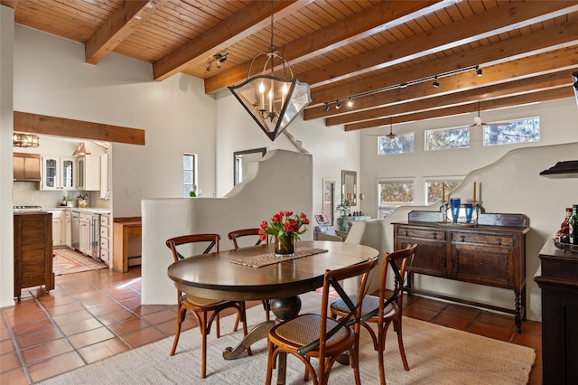 dining area with beamed ceiling, a chandelier, wooden ceiling, and tile patterned flooring