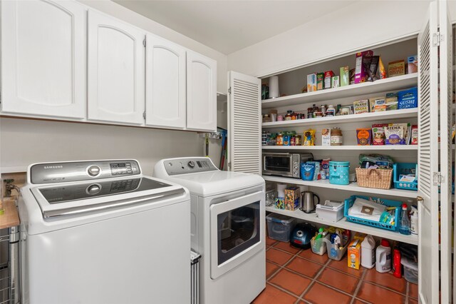 washroom with cabinet space, separate washer and dryer, and tile patterned floors