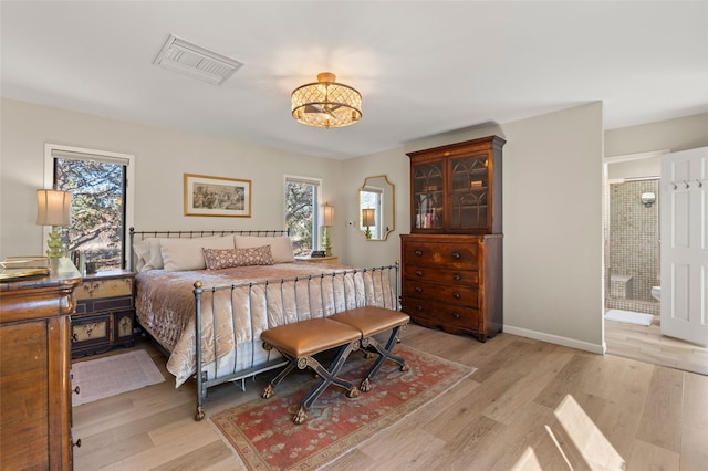 bedroom with multiple windows, light wood-style floors, and visible vents