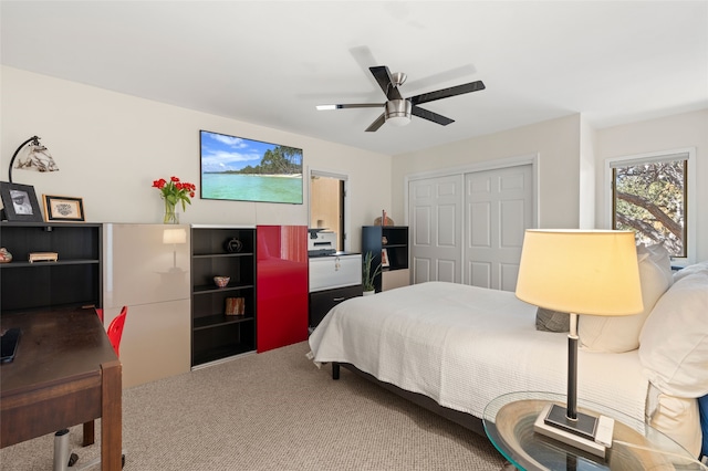 bedroom with a ceiling fan, a closet, and carpet floors