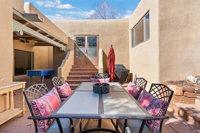 view of patio with outdoor dining space and entry steps