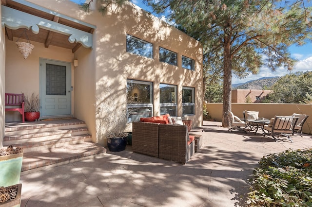 view of patio with an outdoor living space and a mountain view