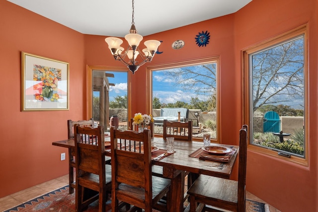 dining space featuring an inviting chandelier and tile patterned flooring