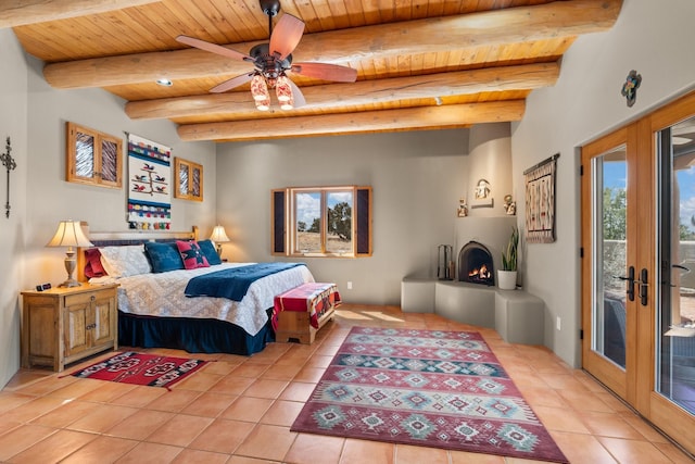 bedroom featuring access to outside, french doors, a large fireplace, wooden ceiling, and light tile patterned flooring